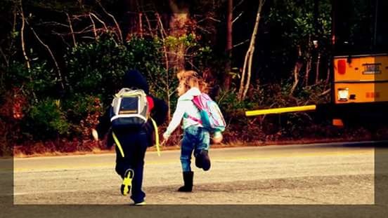 REAR VIEW OF WOMAN WALKING ON ROAD