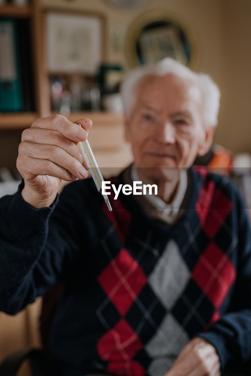 Portrait of man holding camera