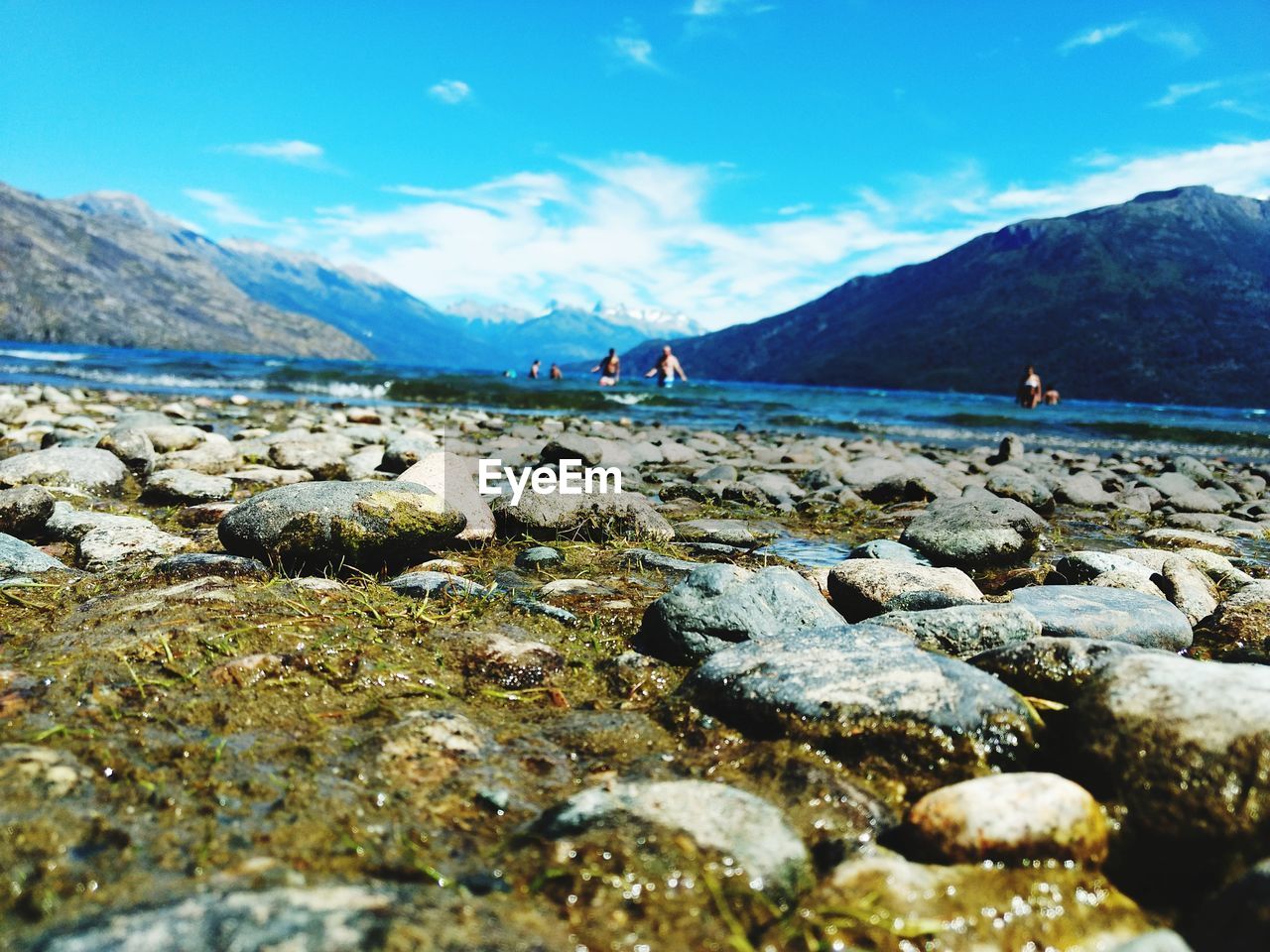 Scenic view of sea and mountains against sky