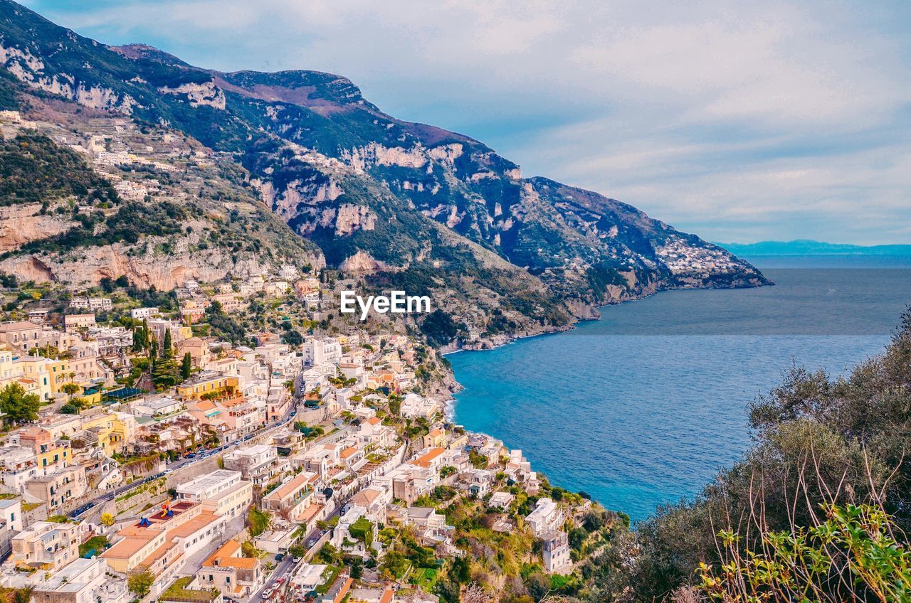 High angle view of sea and townscape against sky