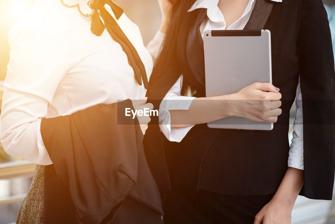 Midsection of businesswoman standing in office