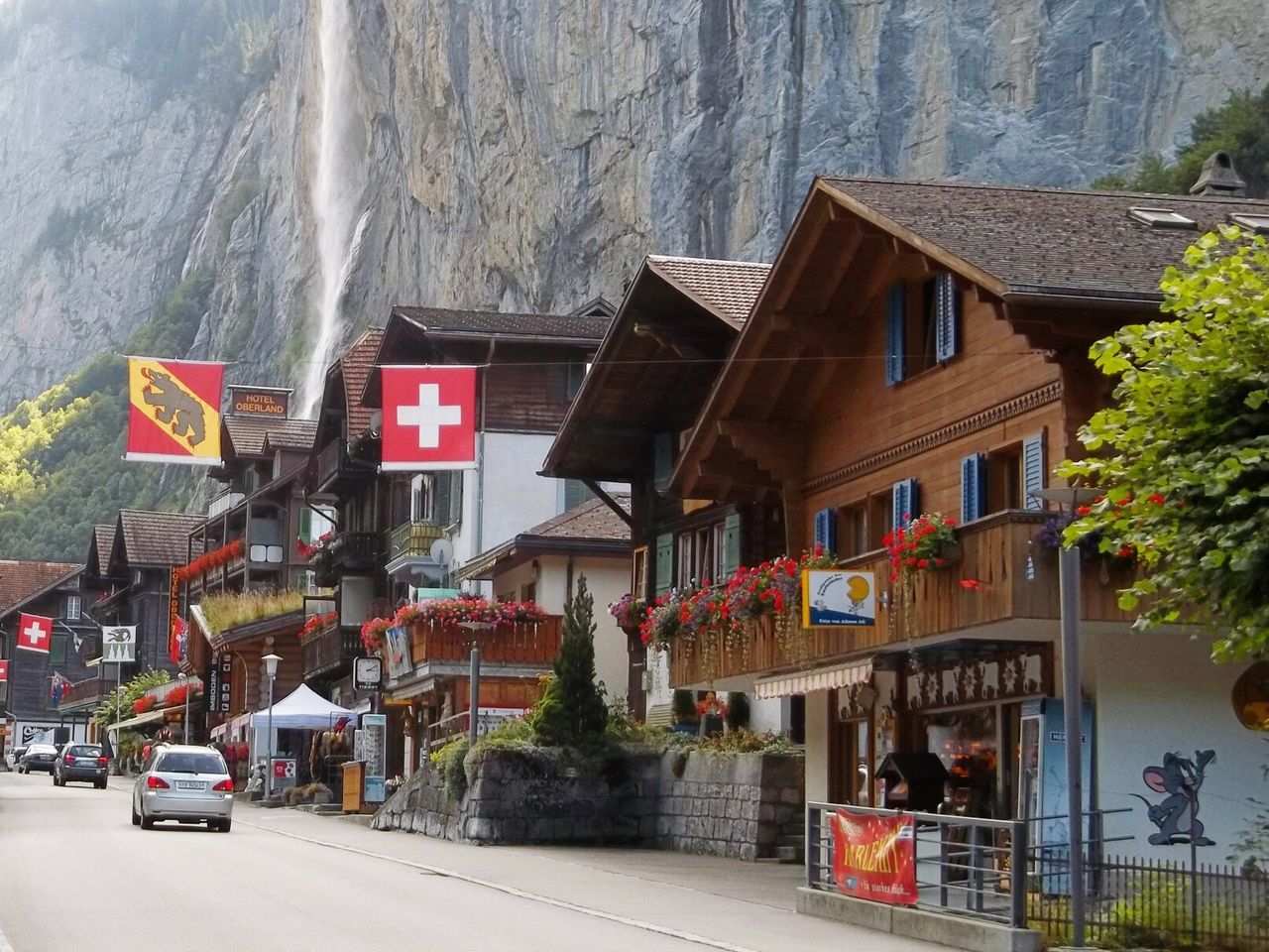 Cars on road along buildings