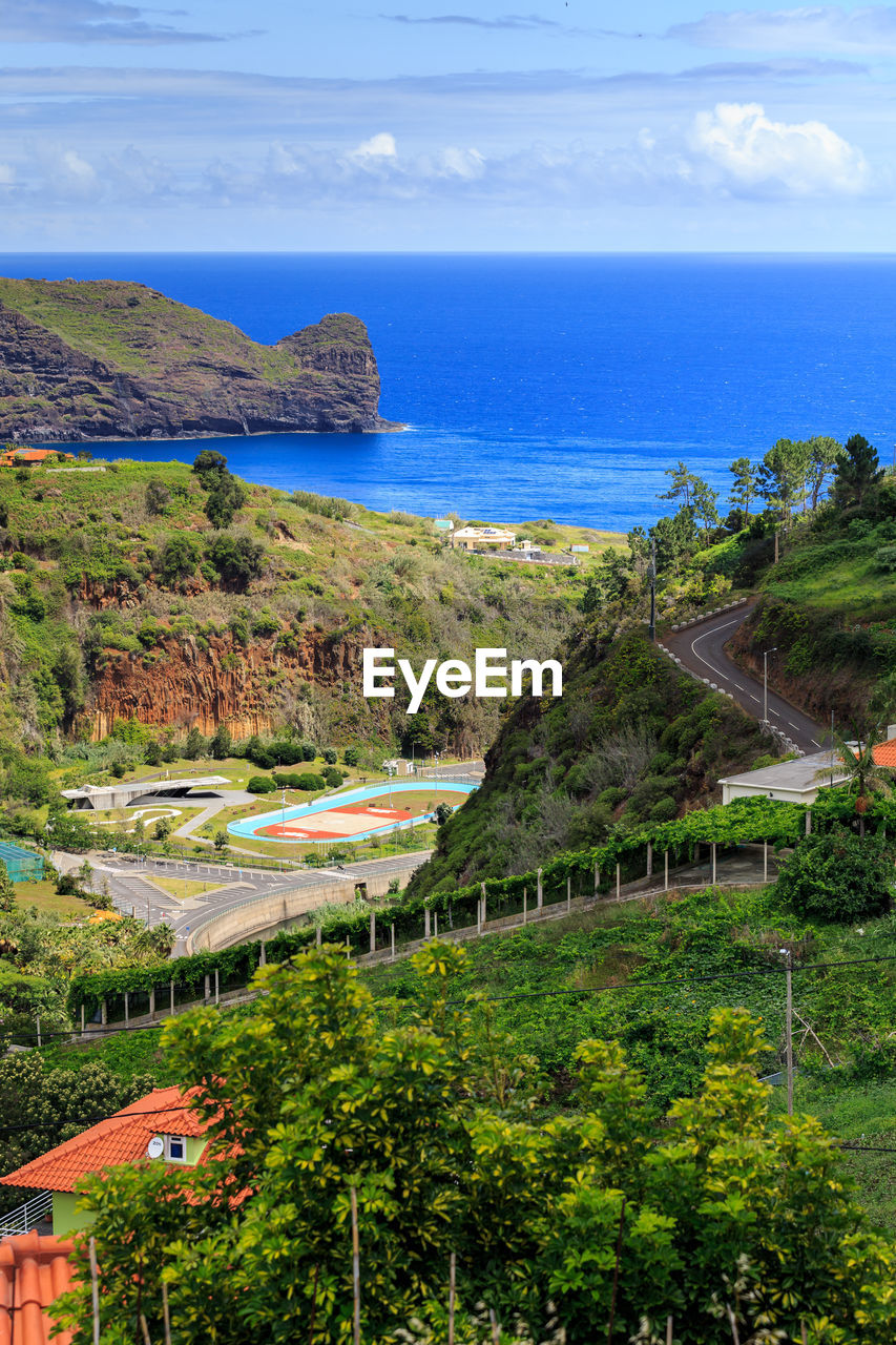 Scenic view of sea and buildings against sky