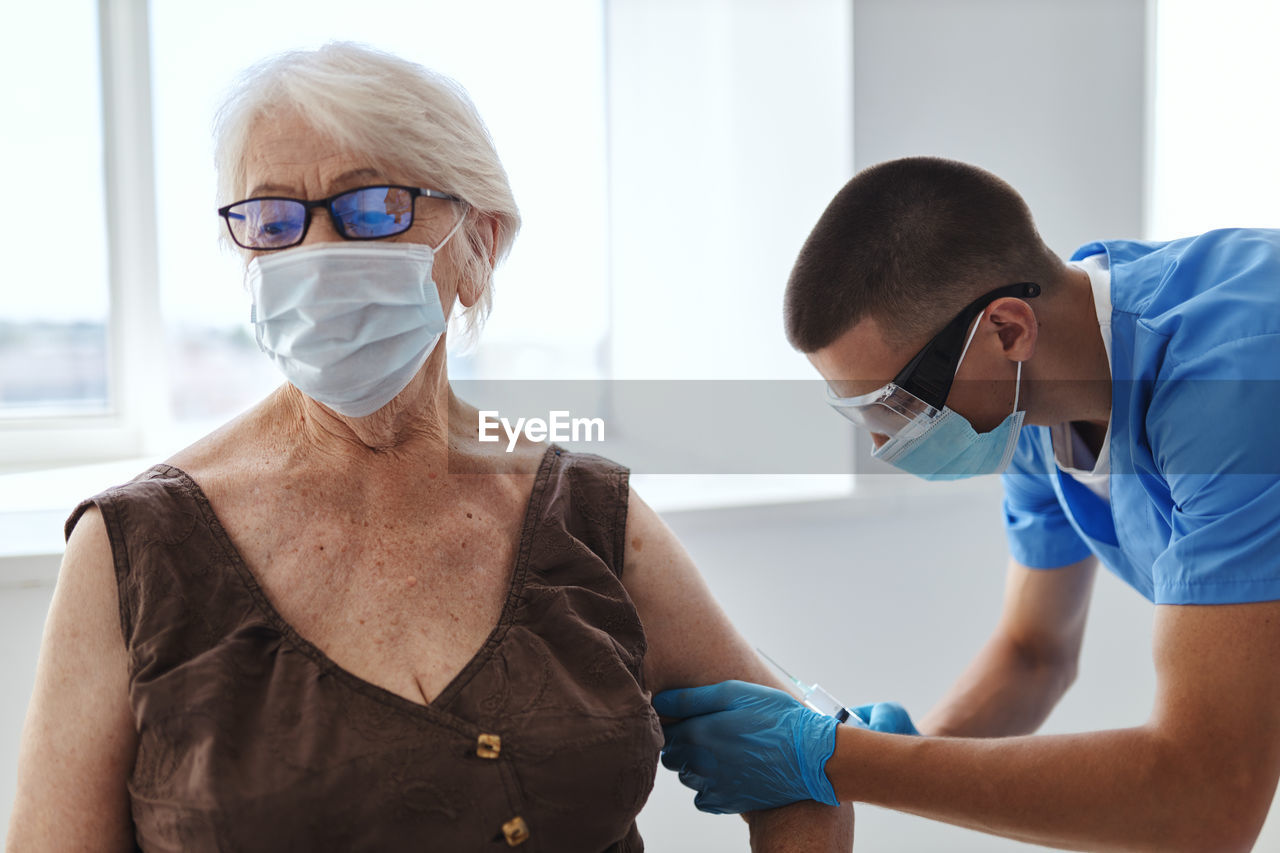 Doctor injecting vaccine to patient