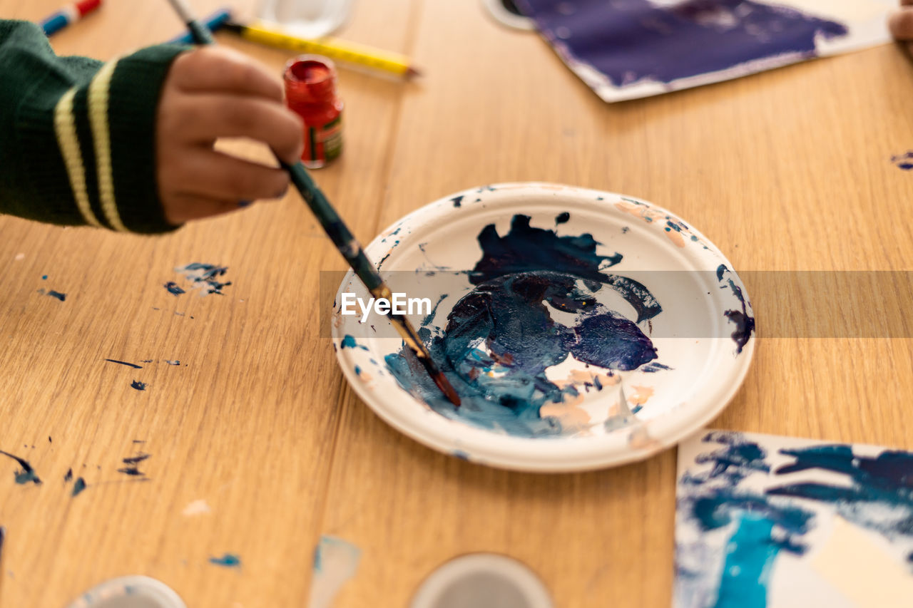 Close up shot of kids doing painting