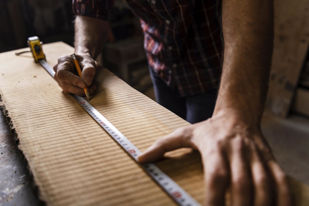 Midsection of carpenter working at workshop