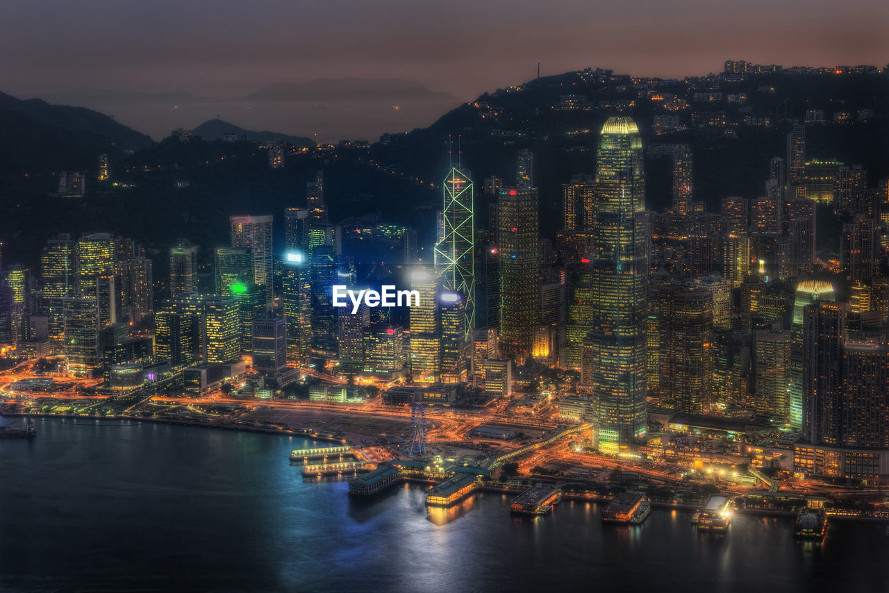ILLUMINATED BUILDINGS IN CITY AT NIGHT
