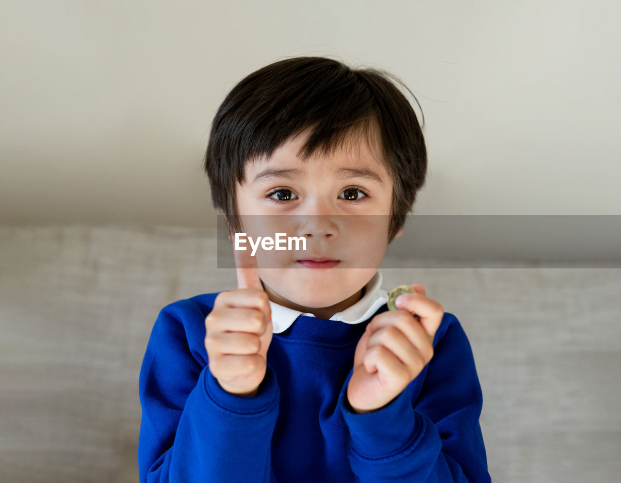 Portrait of cute boy against wall