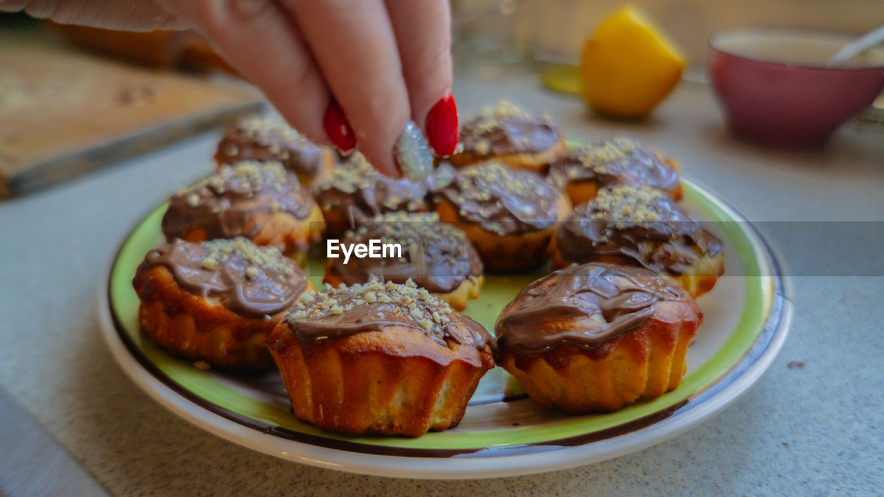 Midsection of person holding food on table