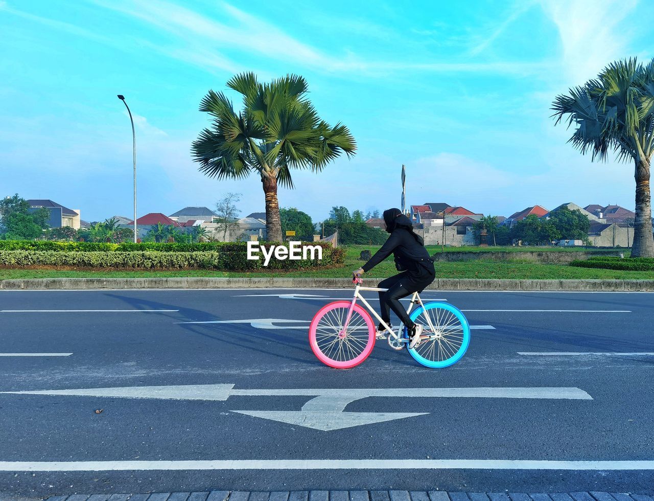 Woman riding bicycle on road