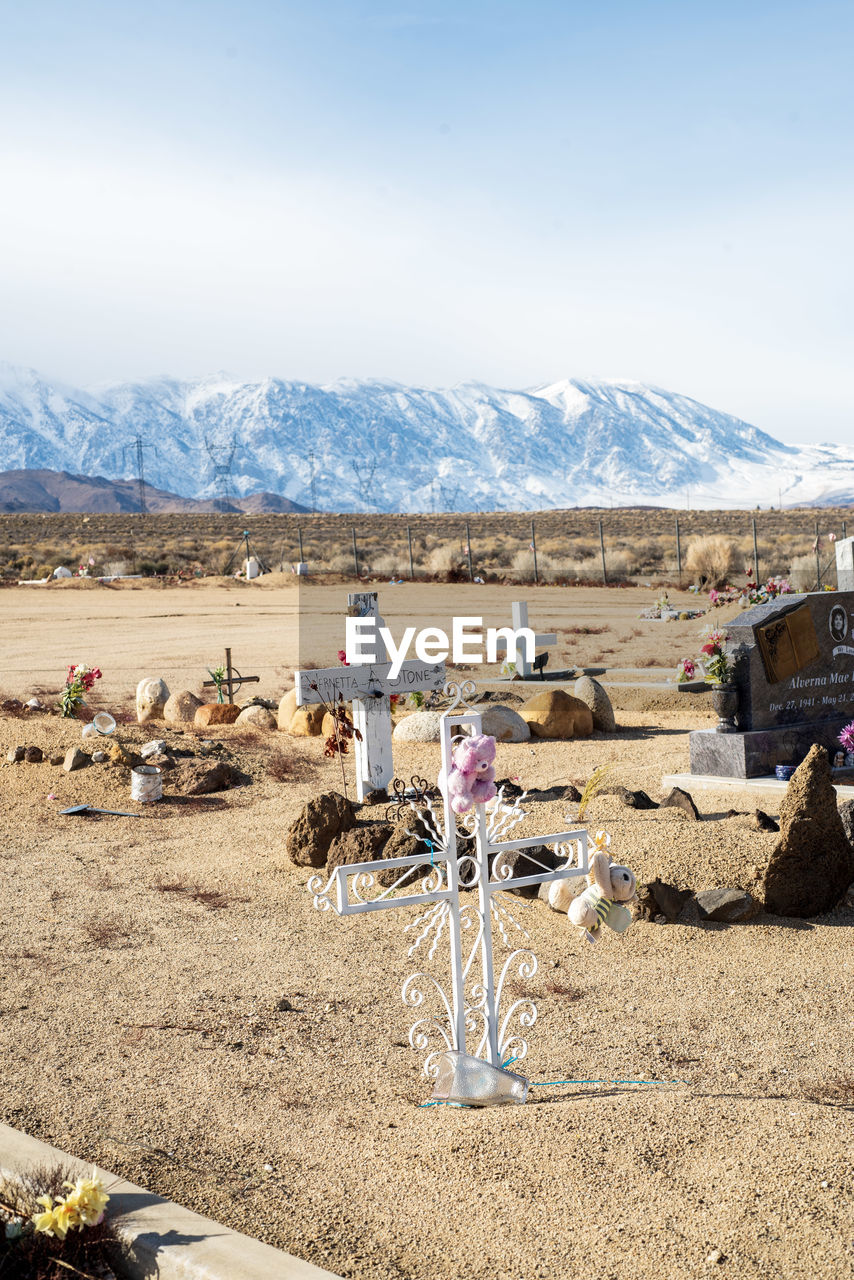 Desert cemetery with distant snowy mountains