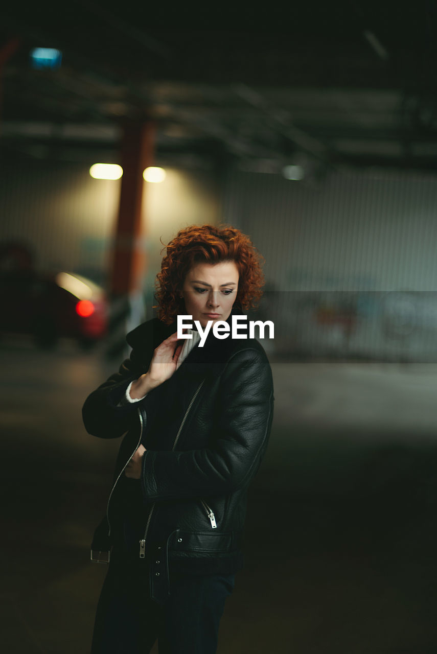 Portrait of a red-haired girl on a dark background