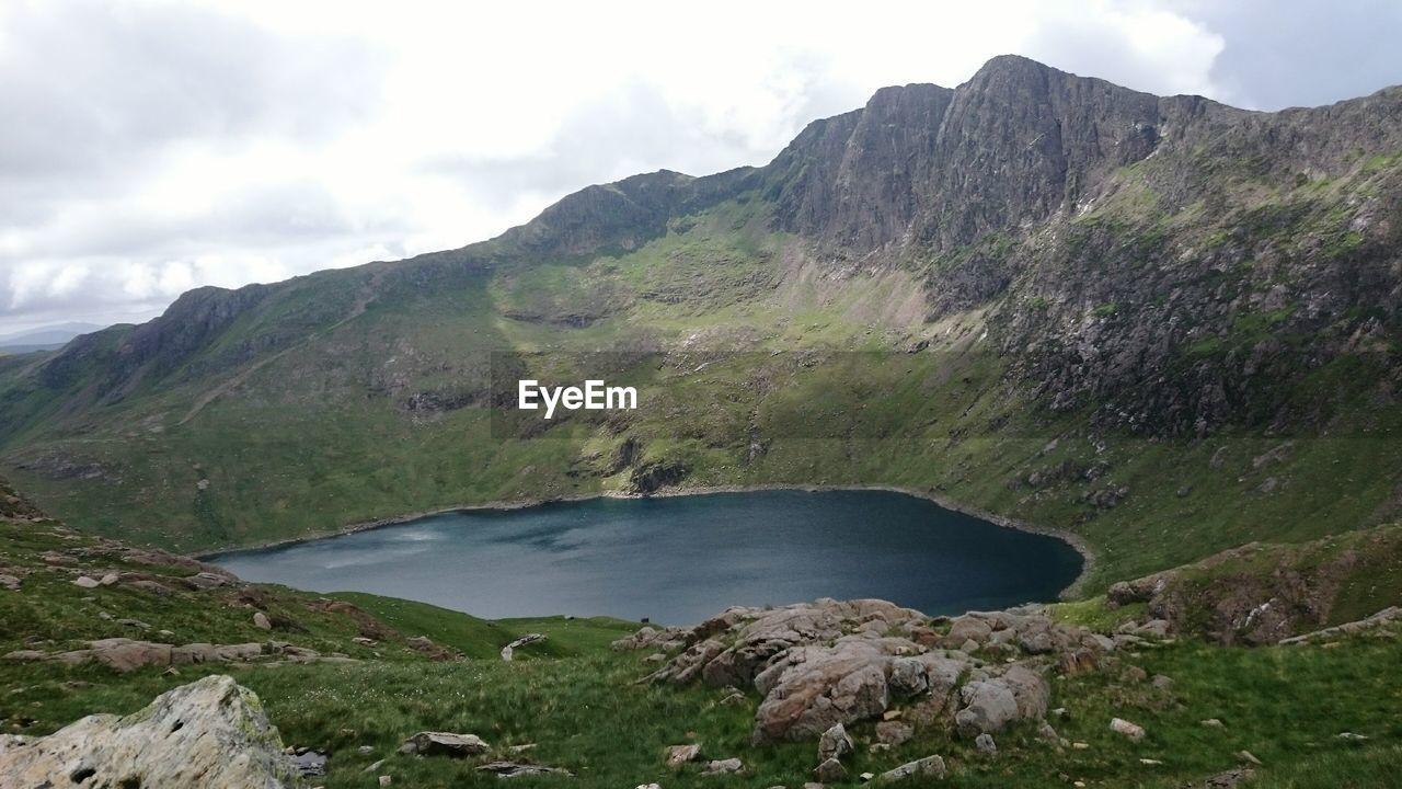 Scenic view of lake and mountains against sky