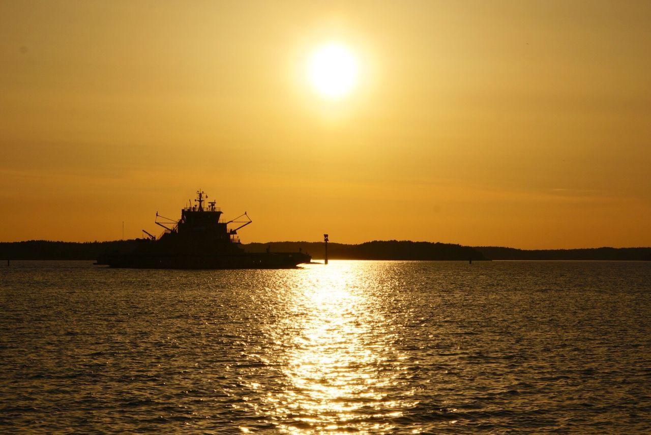 Silhouette ship on sea against sky during sunset