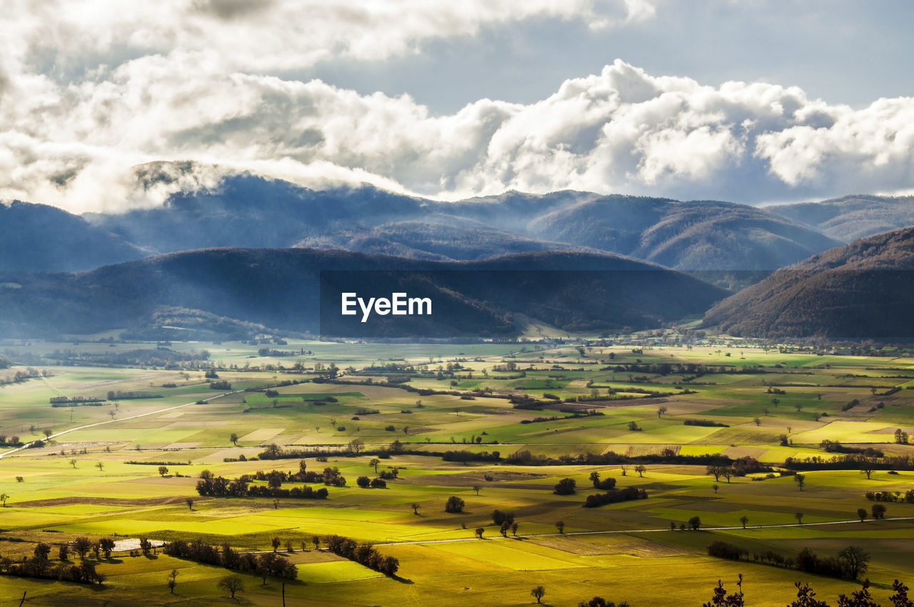 Scenic view of agricultural field against sky