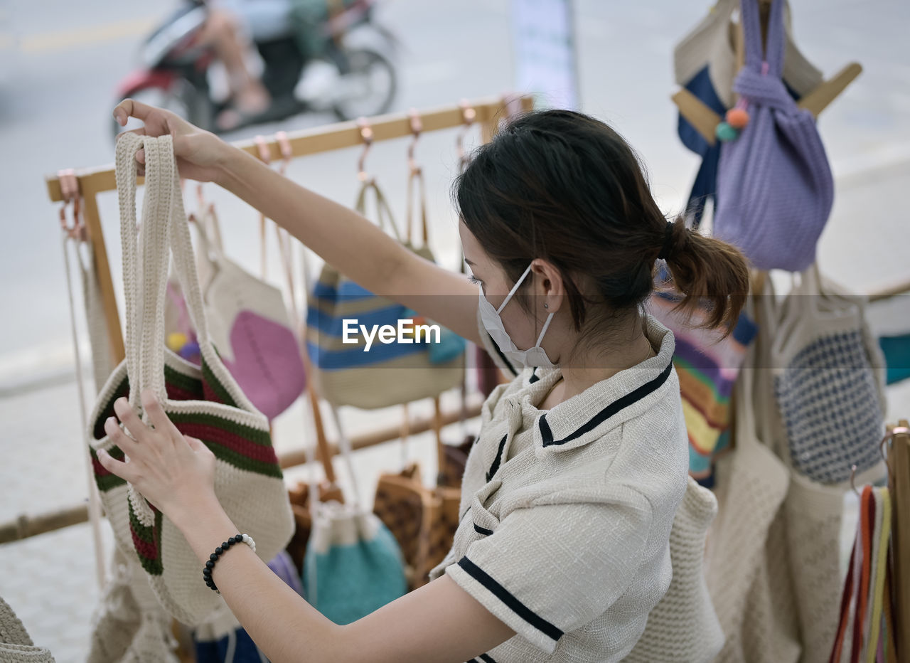 Series photo of young women choosing new shopping bag in street market , refreshing look concept