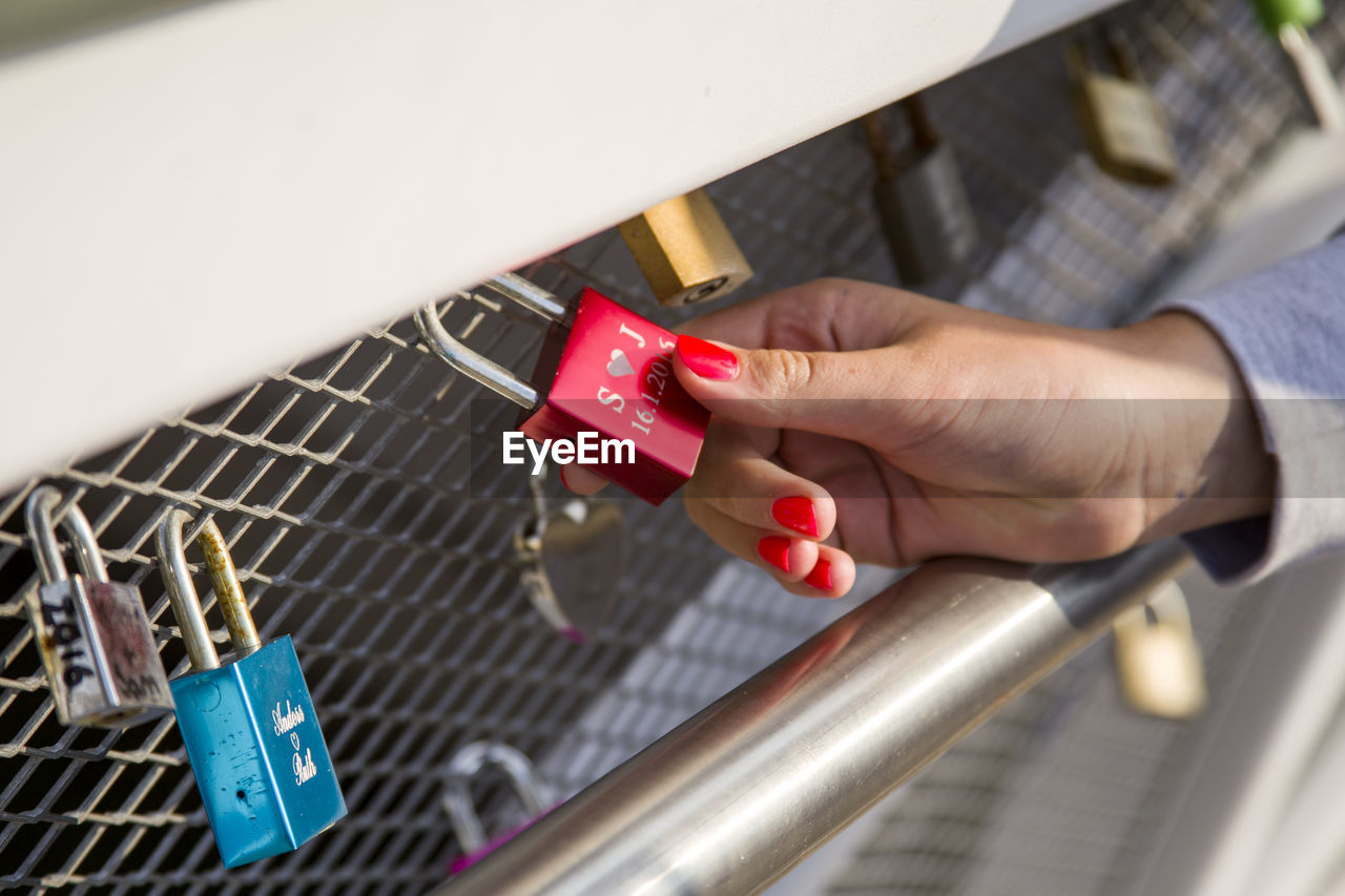 Close-up of woman's hand holding padlock