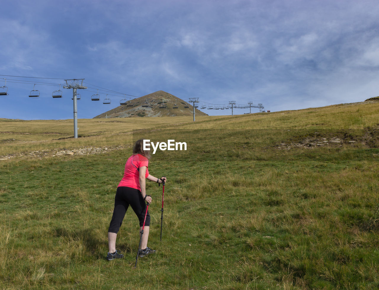 Rear view of woman on field against sky