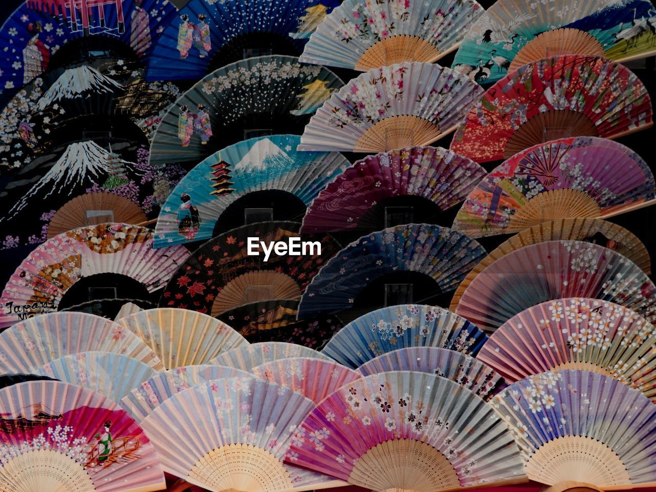 Full frame shot of colorful hand fans for sale in market