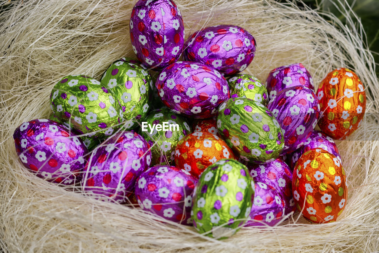 High angle view of multi colored easter eggs in basket