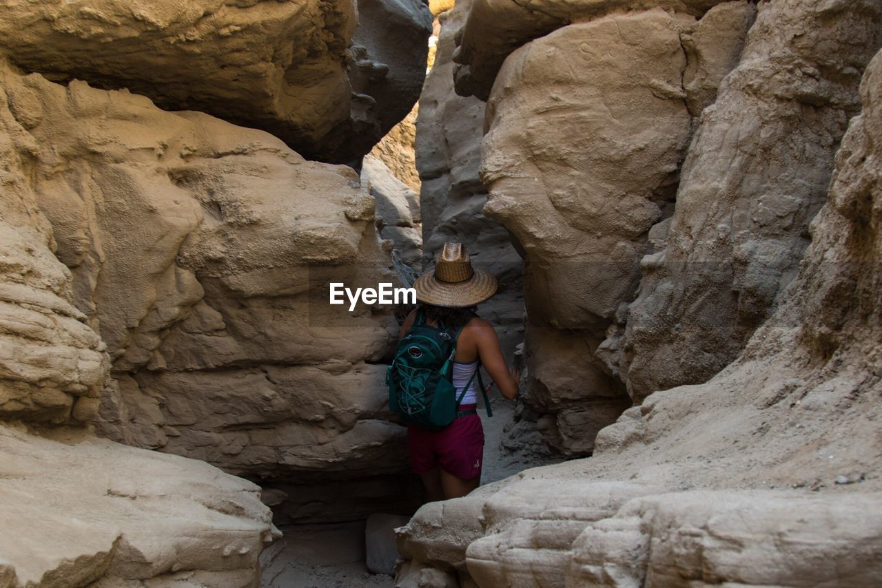 WOMAN STANDING ON ROCKS