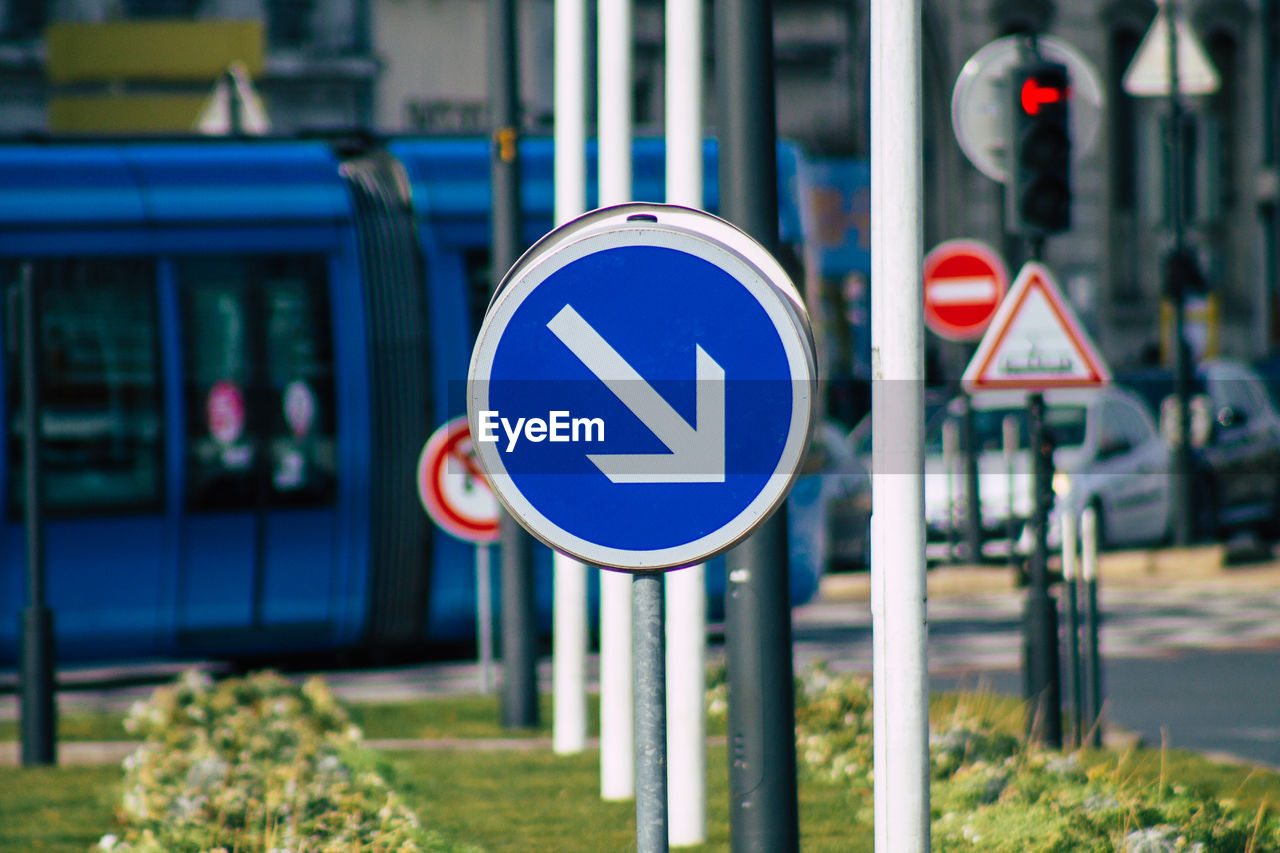 CLOSE-UP OF ROAD SIGN AGAINST BLUE BACKGROUND