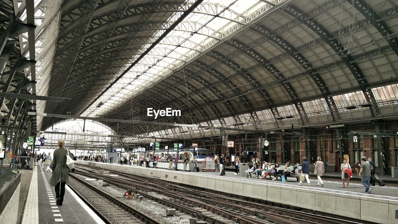 People walking on railway station platform