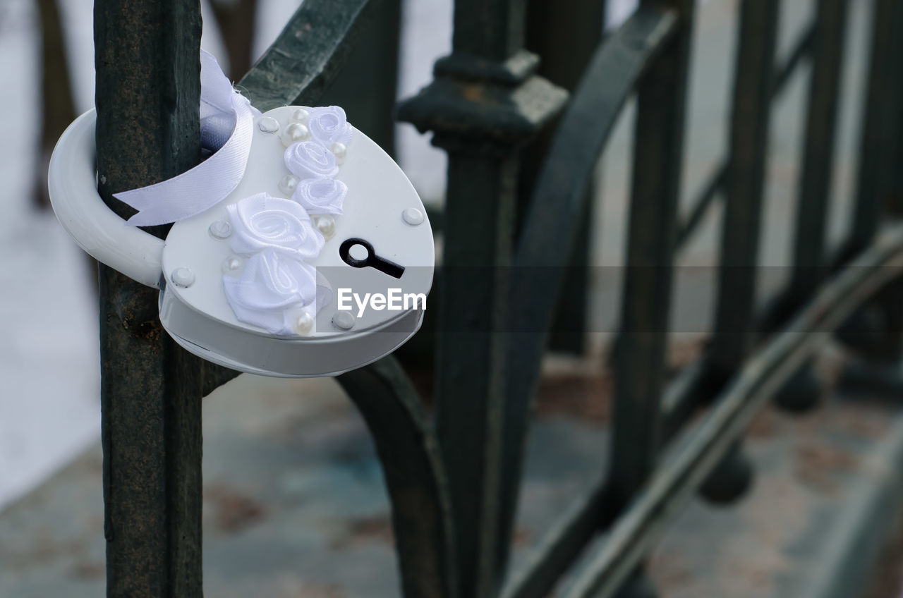 A close-up white wedding lock fastened on a lattice. black and white.