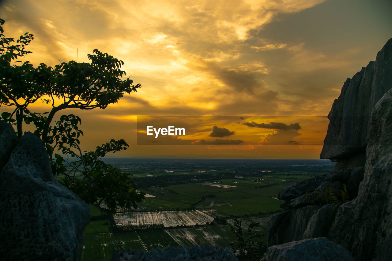 sky, cloud, sunset, nature, scenics - nature, landscape, environment, sunlight, beauty in nature, water, sea, travel destinations, land, architecture, tree, plant, rock, dramatic sky, travel, evening, tranquility, sun, outdoors, dawn, no people, tourism, tranquil scene, horizon, building, city, built structure, cloudscape, trip, orange color, rural scene, vacation, holiday, beach