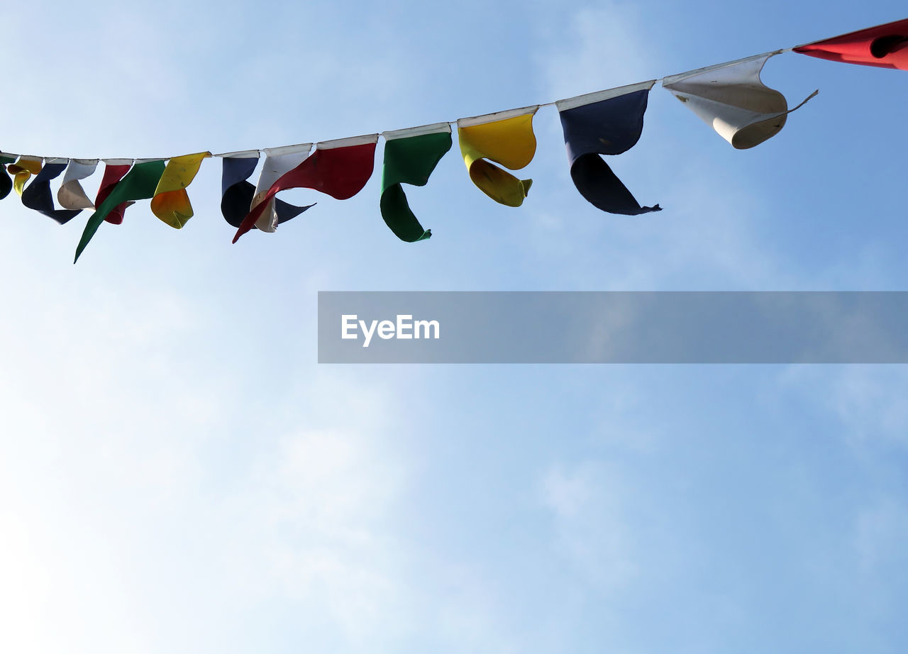 LOW ANGLE VIEW OF FLAGS