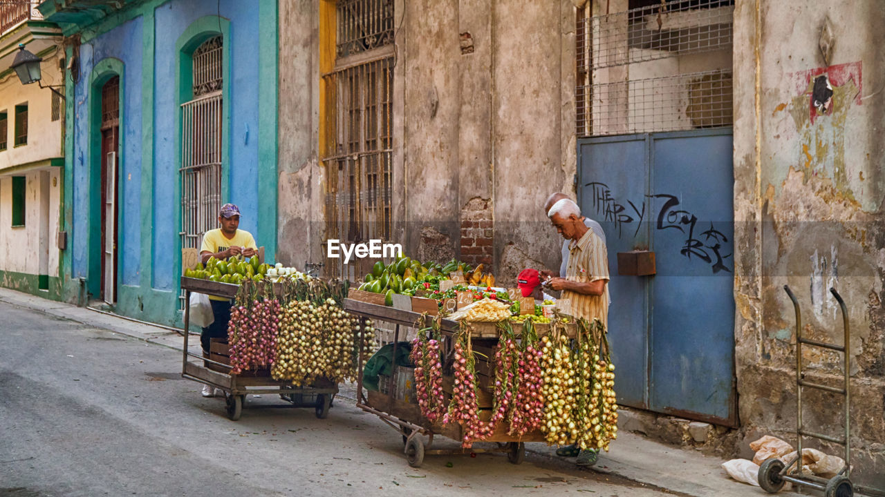 PEOPLE AT MARKET STALL