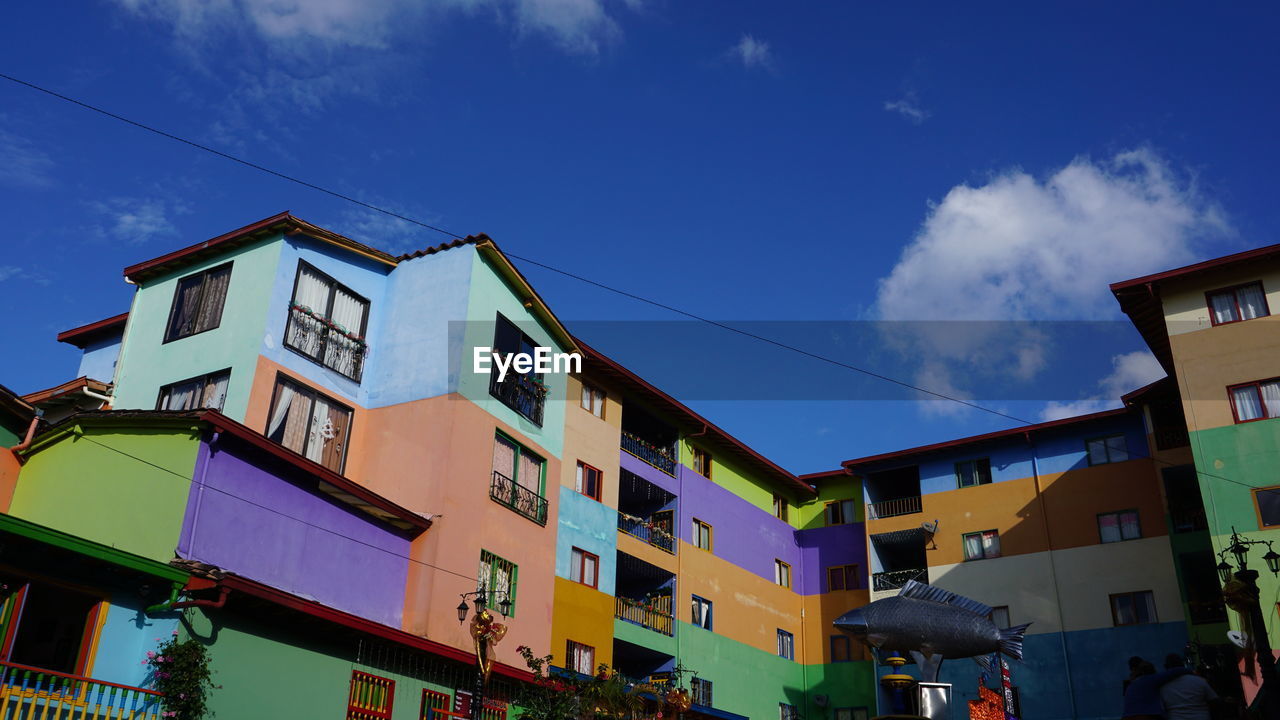 Low angle view of buildings against blue sky