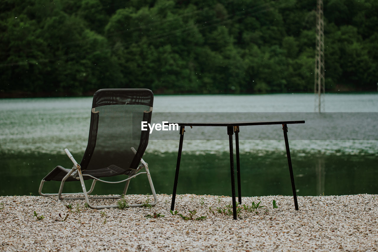 seat, chair, plant, nature, green, absence, no people, tranquility, empty, water, furniture, lake, tree, day, tranquil scene, land, outdoors, relaxation, park, grass, table, beauty in nature, park - man made space