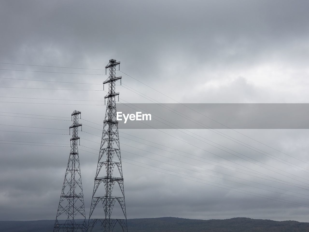 Low angle view of electricity pylon against sky