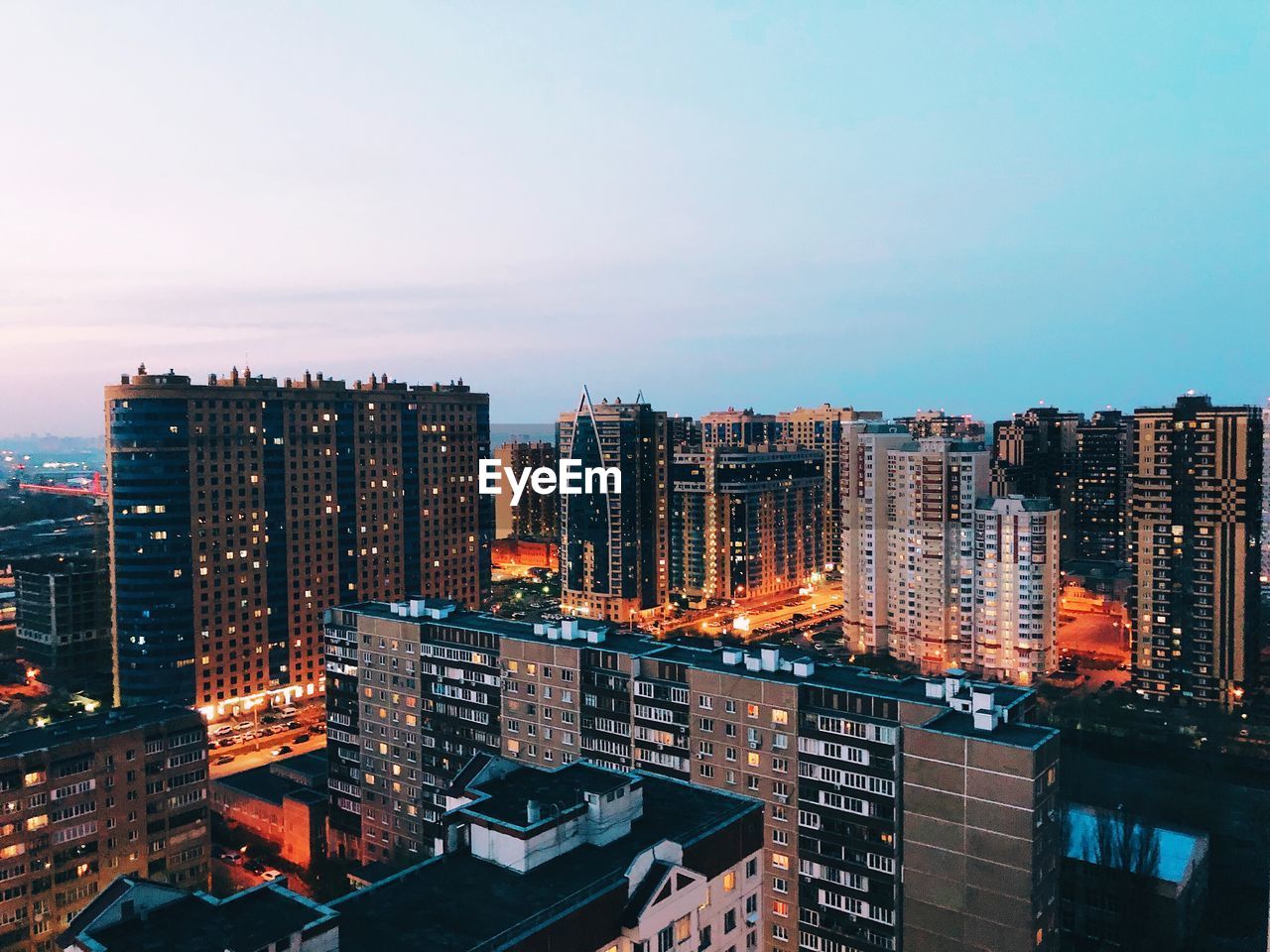 High angle view of illuminated buildings against sky at night