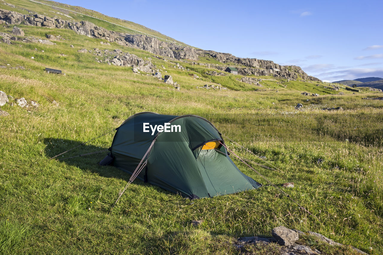 Scenic view of tent on mountain against sky