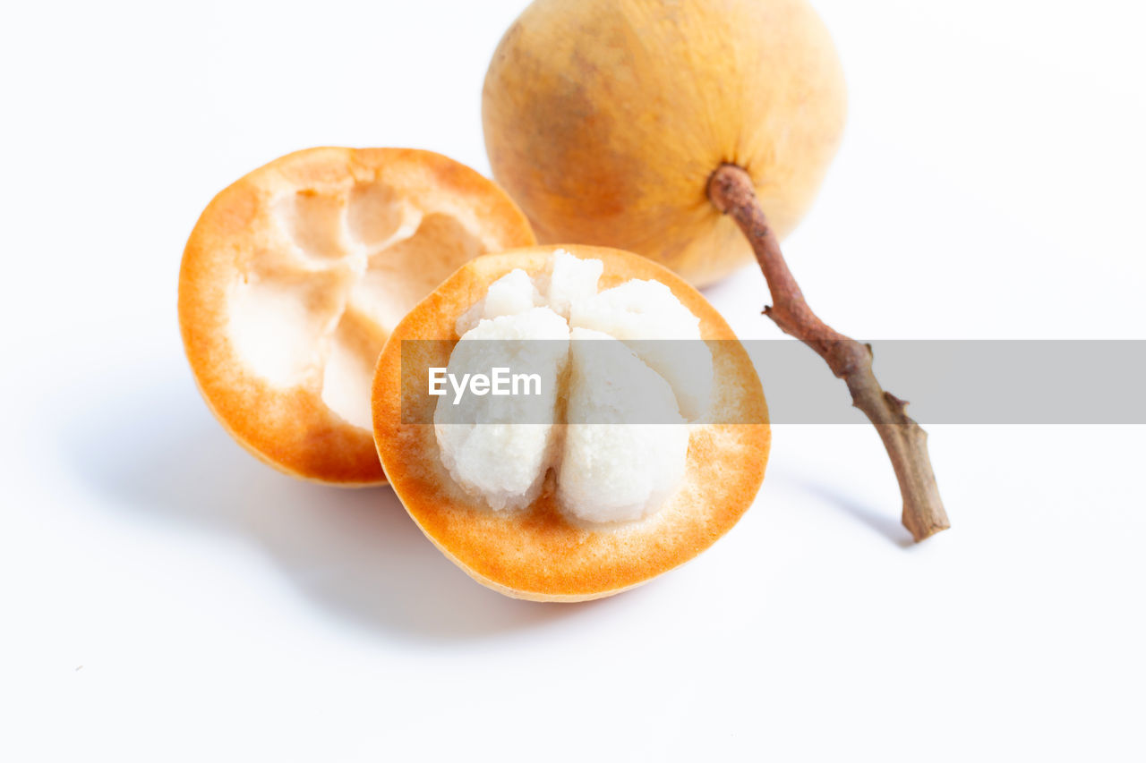 HIGH ANGLE VIEW OF APPLE ON WHITE SURFACE