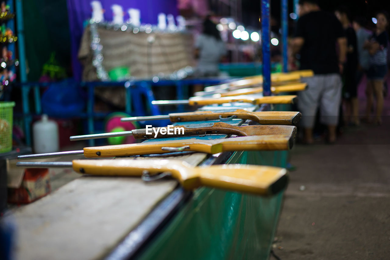 Rifles at carnival booth at night