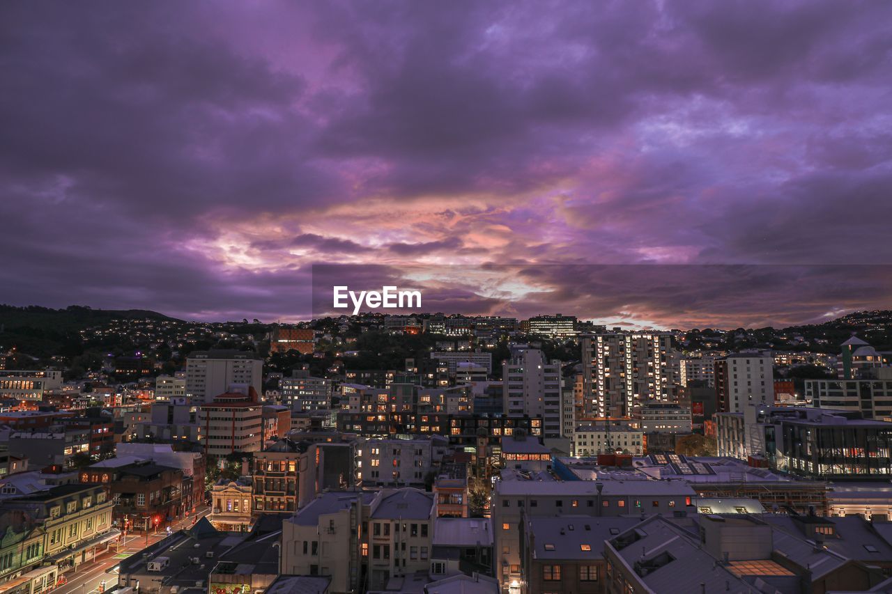 High angle view of illuminated cityscape against romantic sky