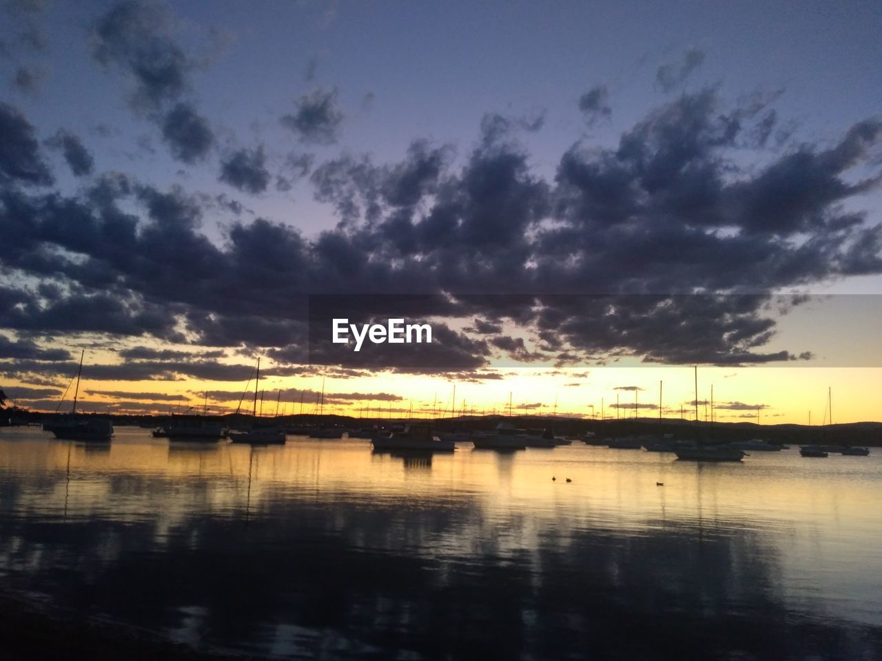 SCENIC VIEW OF LAKE AT SUNSET