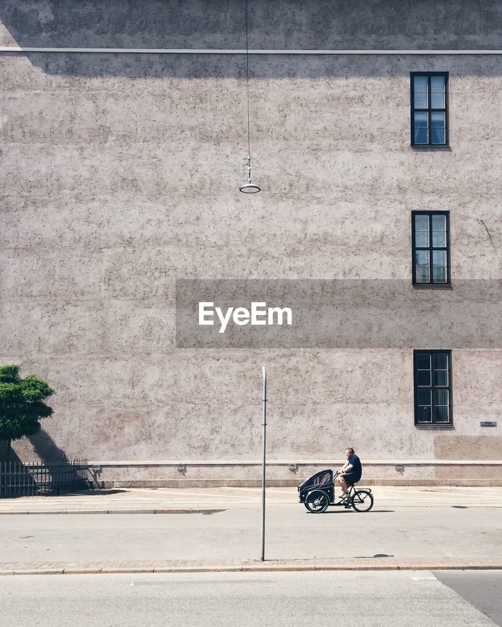 MAN WITH BICYCLE ON ROAD