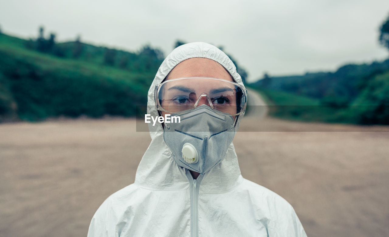 Female scientist wearing protective workwear while standing outdoors