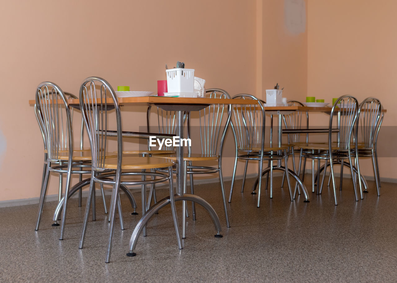 School kitchen canteen, metal table and chair legs, canteen equipment, catering establishment