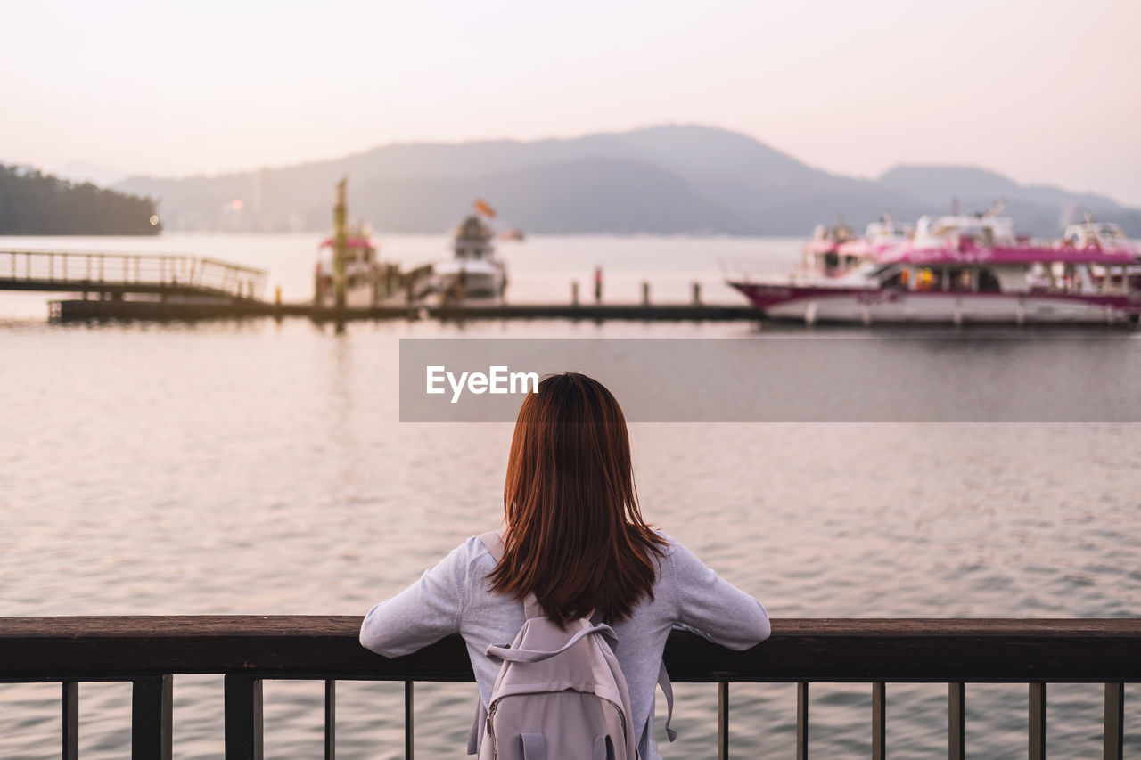 Rear view of woman looking at lake