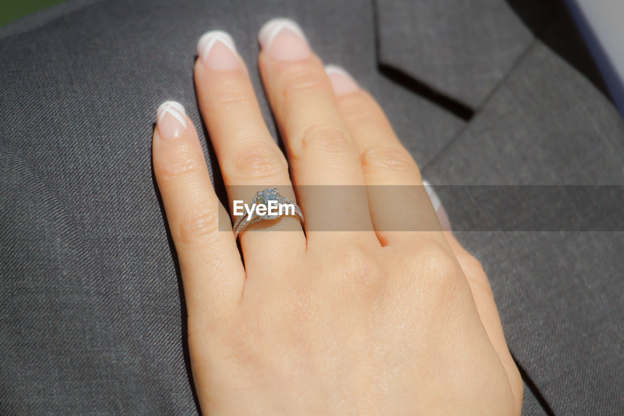 Close-up of woman hand showing engagement ring