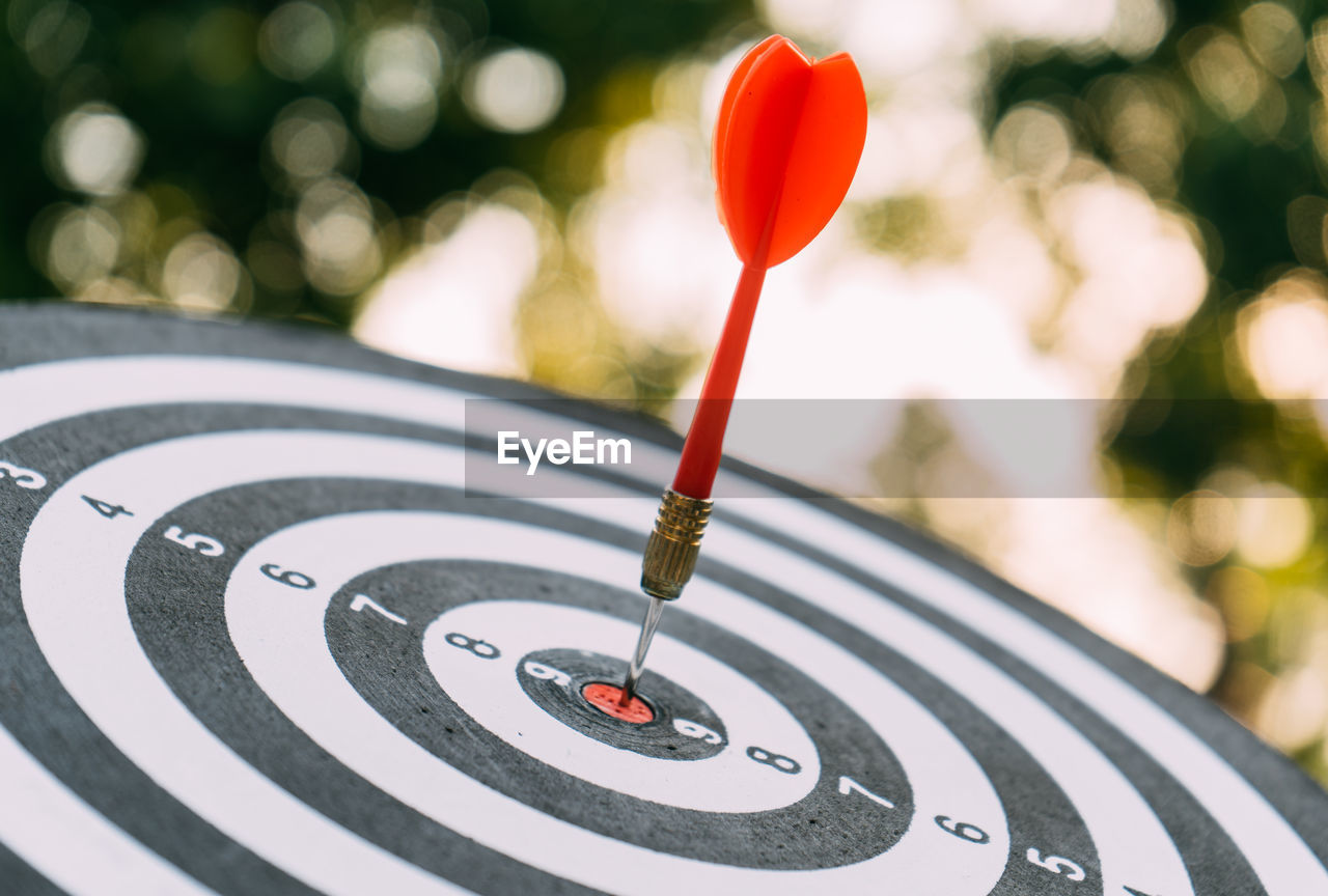 Target dart and arrow with abstract nature bokeh blur background