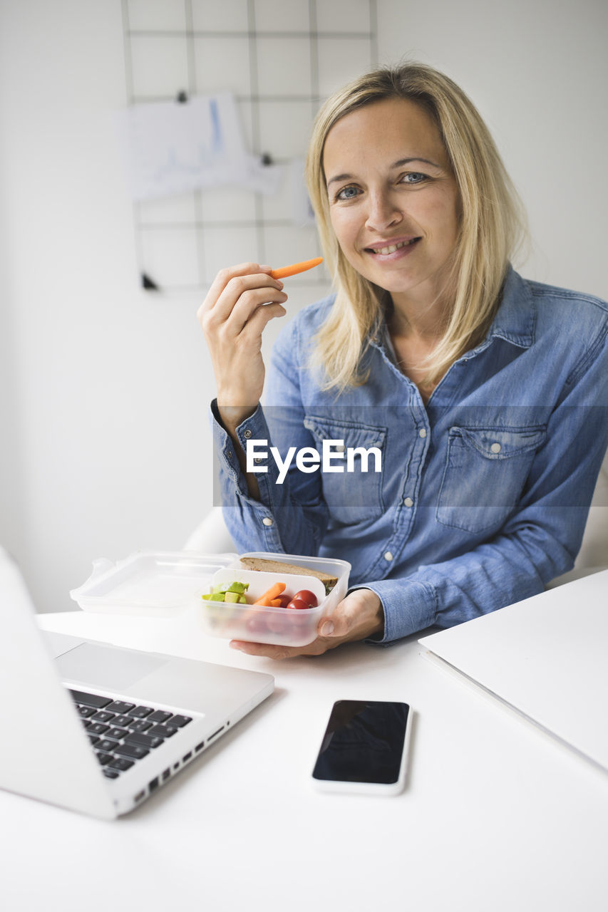 Portrait of woman eating food