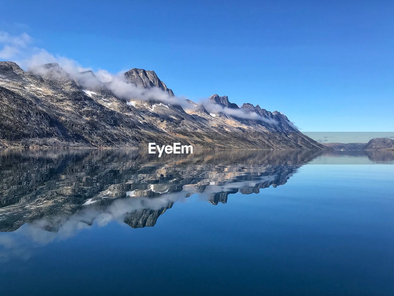 Scenic view of lake against blue sky