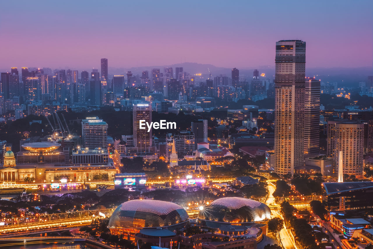 Aerial view of illuminated buildings in city at night