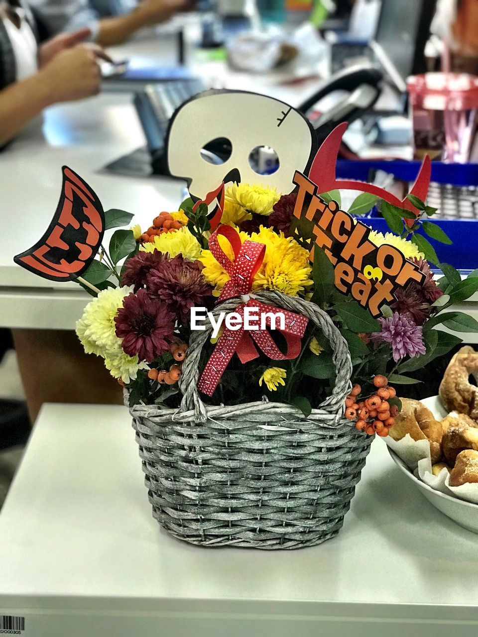 CLOSE-UP OF FLOWER IN BASKET ON TABLE